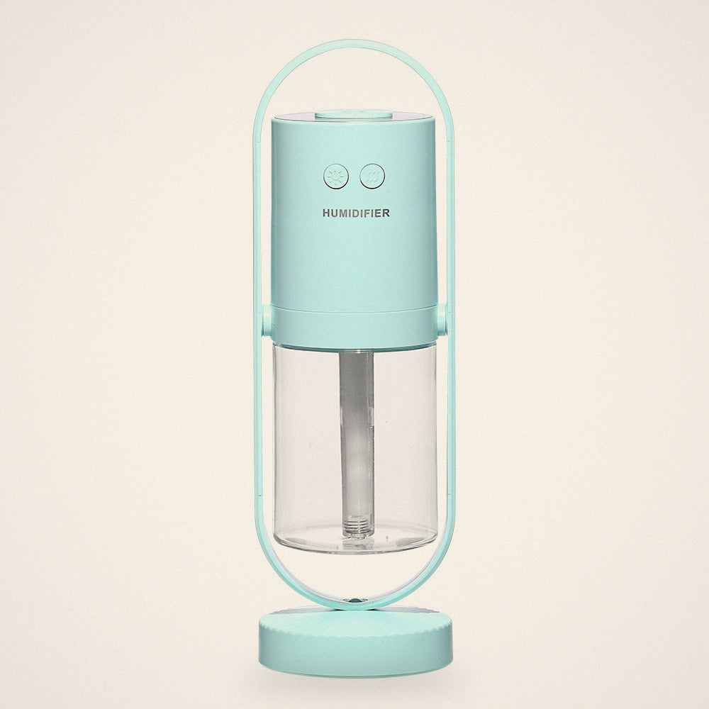 Light Blue mini USB humidifier in its oval stand with a clear water tank, front view