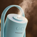Close-up of cool mist from the light blue mini USB humidifier